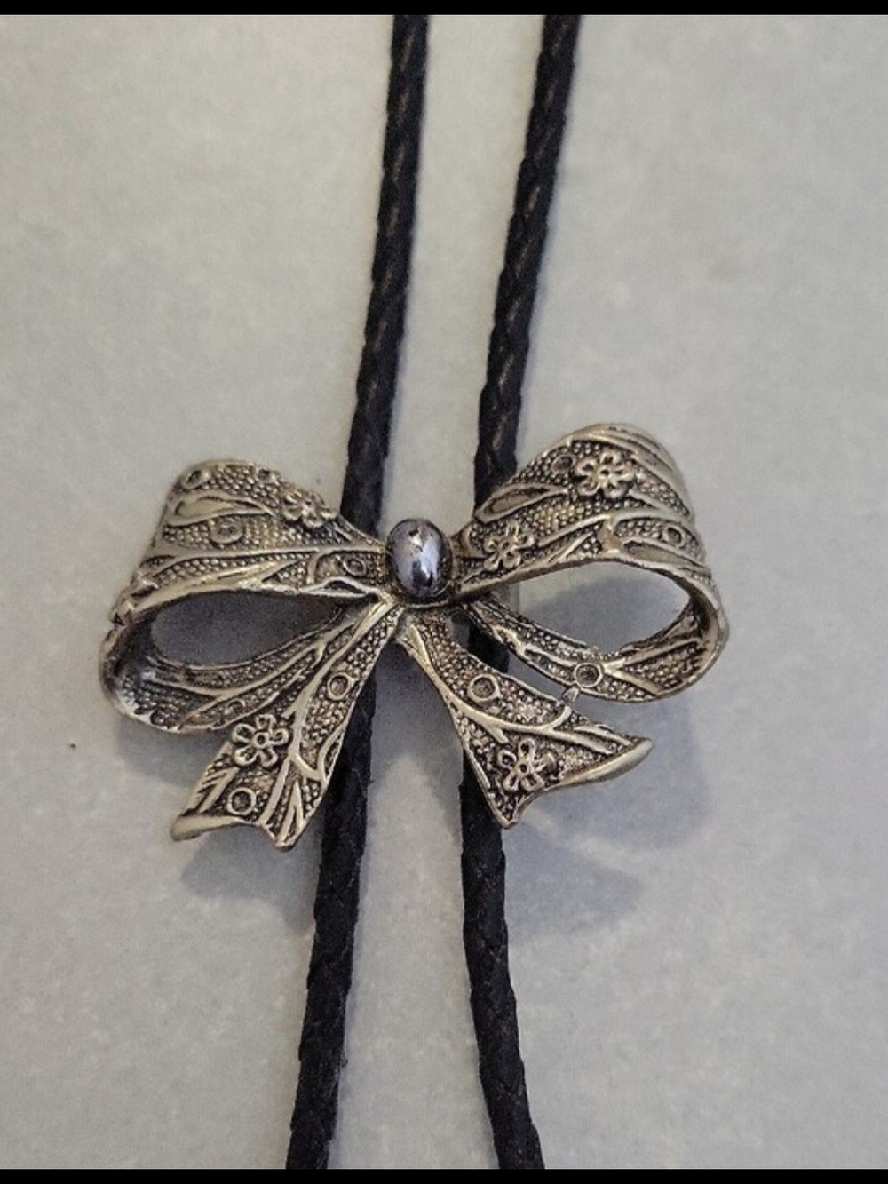 Vintage Western Black Leather Braided Bolo Tie with Decorative Engraved Bow